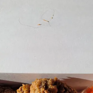 A lil hair fried into the chicken never killed anyone. Still not very pleasant.