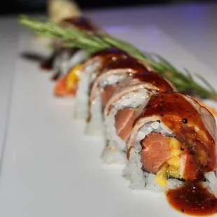 The El Diablo Roll is made with kani, salmon, &amp; mango then topped with seared Kobe beef, the chef&apos;s special black pepper sauce, &amp; onion sasa