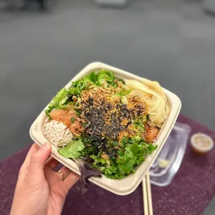 a person holding a bowl of food