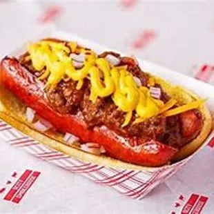 a hot dog with cheese and mustard