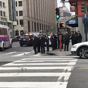 a group of police standing at a crosswalk