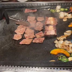 a steak being cooked on a grill