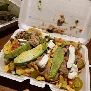 Chicken and fajita nachos with cilantro and avocados