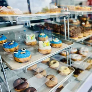 a variety of donuts in a display case