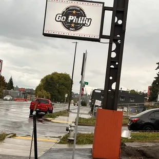 a red truck parked in front of a gas station