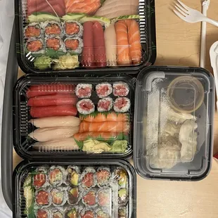 a tray of sushi and vegetables