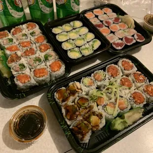 three trays of sushi and two cans of soda