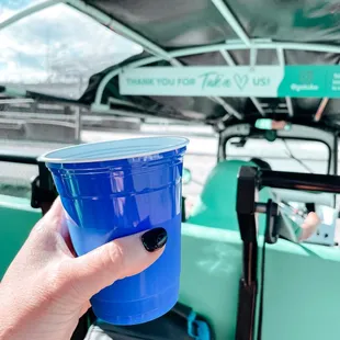 a person holding a blue cup
