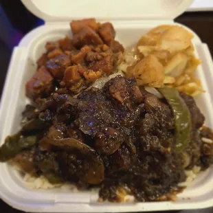 Oxtails over rice, candy yams and cabbage.