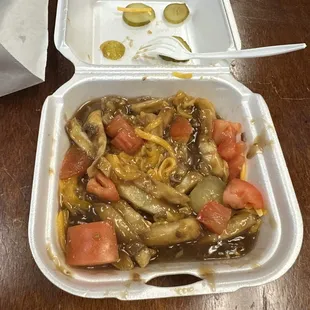 Debris Fries (ate some) with cheese, tomato, and pickle.