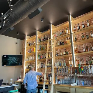 a man standing in front of a bar