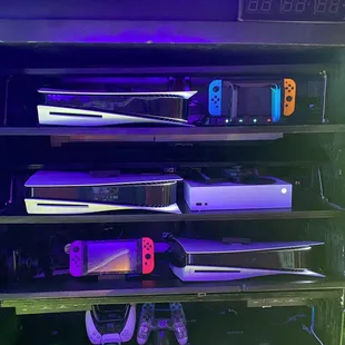 A glimpse of our consoles, we have 3 PS5, 2 Nintendo Switches and an Xbox Series S. We have other consoles not pictured.