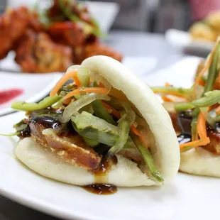 Pork belly Bao. Crispy pork belly inside homemade Bao bun topped with a spicy house slaw and hoisin sauce.