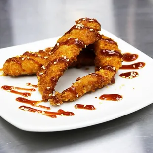 Katsu Chicken Tenders. Chicken breast strips rolled in panko bread crumbs with a drizzle of home made katsu sauce.