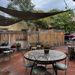 a patio with a table and chairs