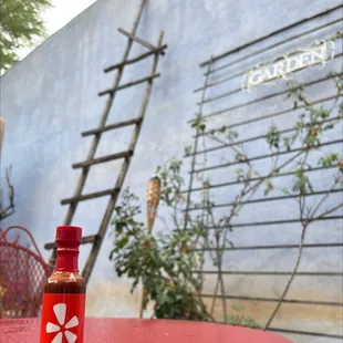 a hot sauce sitting on a table