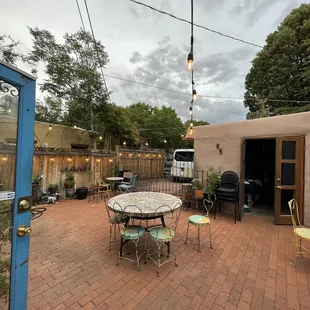 a patio with a table and chairs