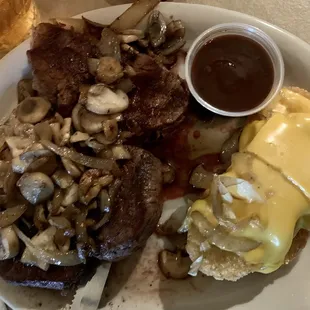 Tenderloin with onions and mushrooms and cheesy hashbrowns on the side.