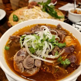 a bowl of soup with meat and vegetables