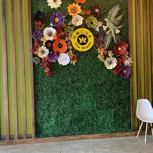 a green wall with flowers