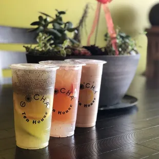 Passion Fruit Honey Oolong Tea with chia and aloe Vera, peach strawberry Oolong Tea with lychee jelly, and Buddha milk tea