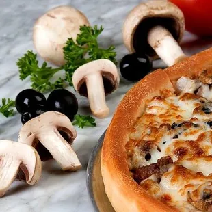 a pizza with mushrooms and olives
