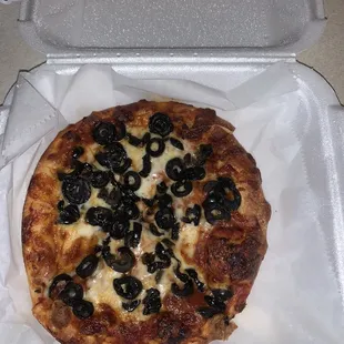 Personal pan pizza with black olives.