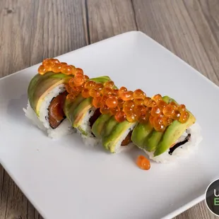 a sushi roll with avocado and salmon roee