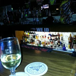 a glass of wine on a bar