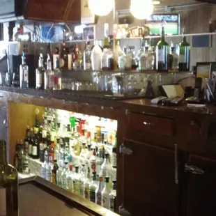 a bar with many bottles of alcohol