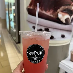 a hand holding a drink