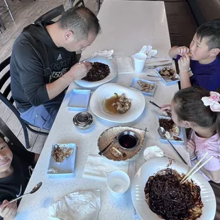 Jjajangmyeon (black bean noodles), tangsuyuk (sweet and sour pork), and pan-fried dumplings