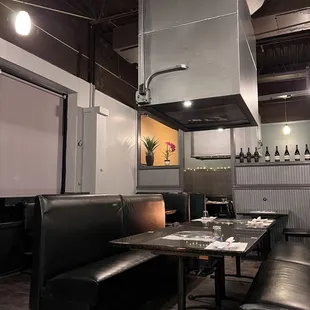 an empty restaurant with black leather booths