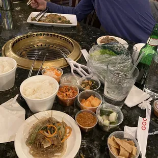Japchae &amp; Banchan (pickled sides: kimchi, moochae, cucumber, aburage/tofu strips, shredded carrot/daikon, jalapeño/onion, lettuce)
