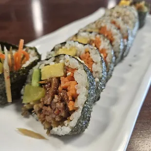 a plate of sushi rolls