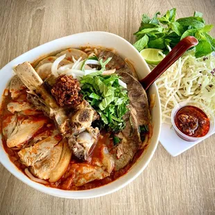 Spicy noodles soup (Bun Bo Hue) (Beef Ribs, Beef shank, Pork shank, Pork Ham with  thick Rice noodles in  Heathy Beef broth)