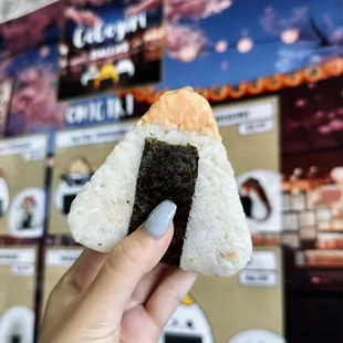 a hand holding a piece of food