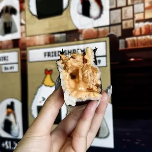 a hand holding a piece of food