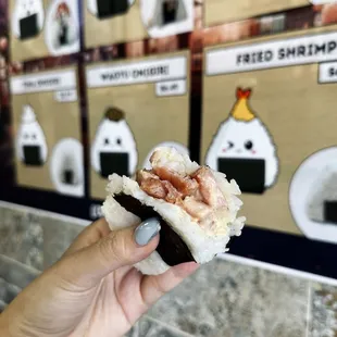 a hand holding a piece of food