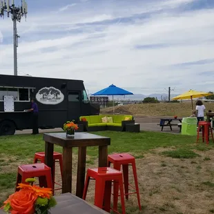 a black food truck parked in a field