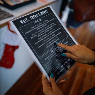 a woman holding a menu