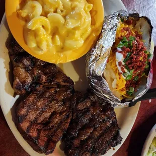 Medium well 8 kz ribeye with baked potato and Mac and cheese