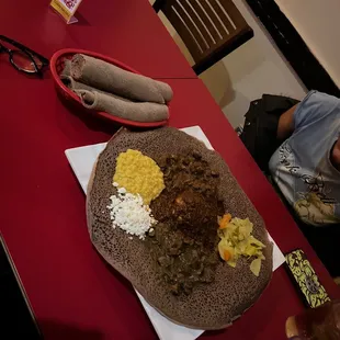 a woman sitting at a table with a plate of food