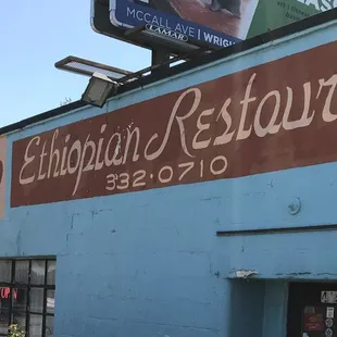 a blue building with a sign for a restaurant