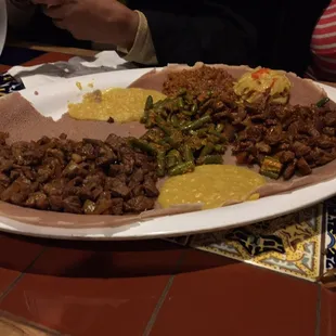 Vegetarian combo and 2 variations of Yebeg(lamb) served with plenty of injera