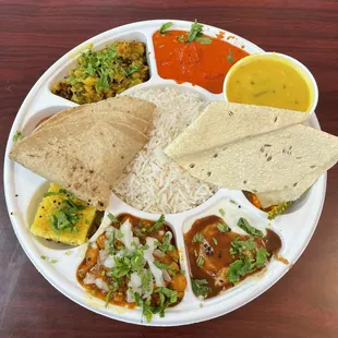 Veg Thali - dahi vada, dhokla, chana masala, undhiyo, paneer butter masala, dal, chapati