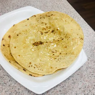 Roti - Indian flatbread - with ghee/butter. The top one was freshly made but he bottom one was slightly stale.