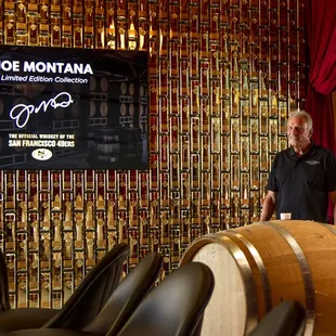 a man standing in front of barrels