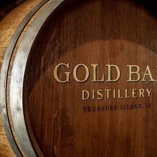 a wooden barrel with gold lettering