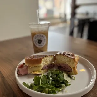 a plate with a sandwich and a drink